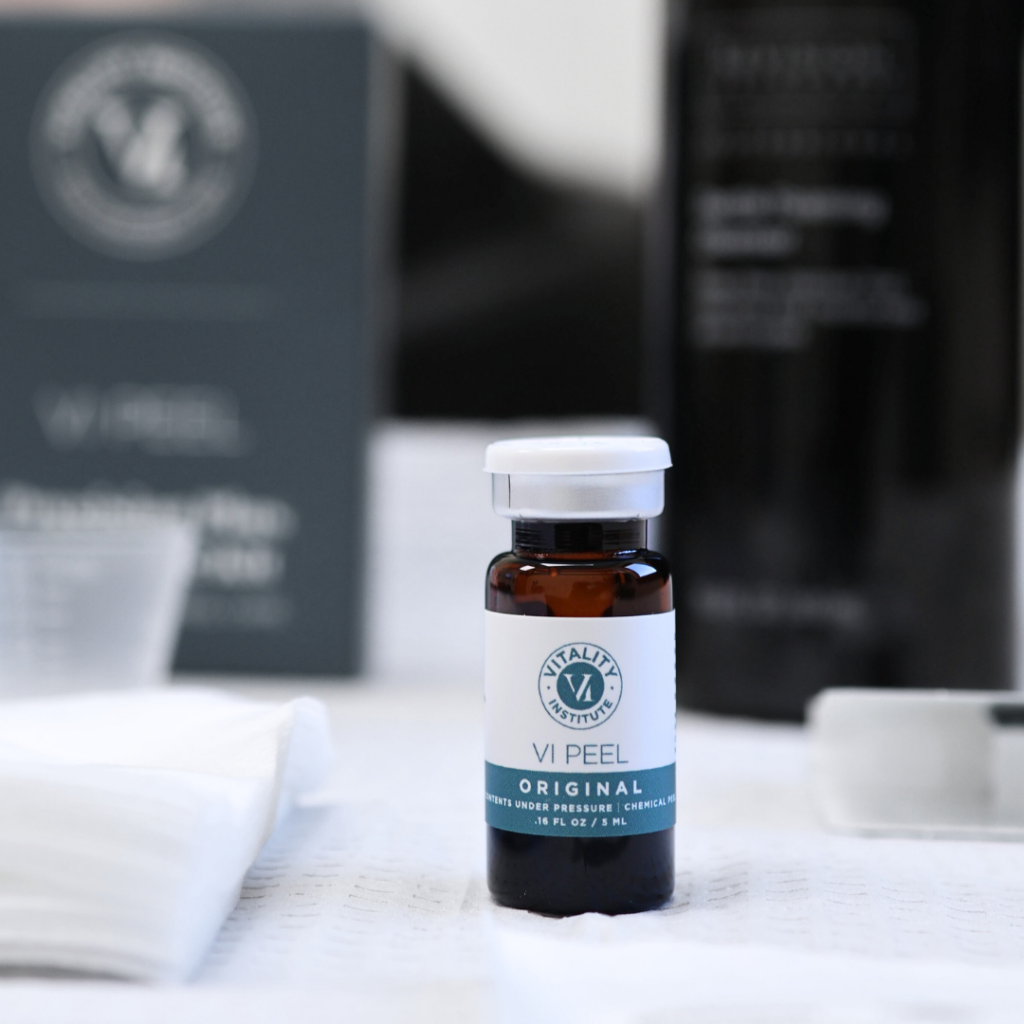 A bottle of VI Peel product on a white cloth.